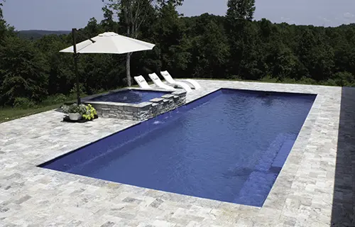Leisure Pools The Grand rectangular fiberglass composite pool for lounging, installed by Leisure Pools Cincinnati